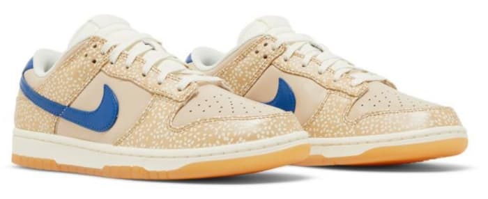 View of tan and blue Nike Dunk shoes.